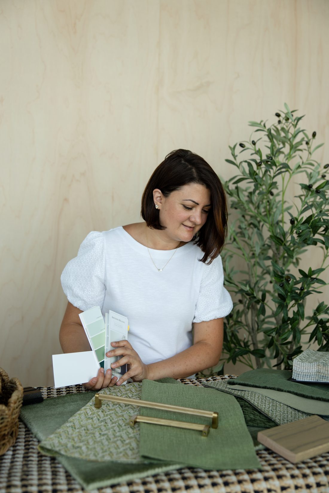 Dana MacAulay, founder of Calm Clarity Interiors, reviewing material samples
